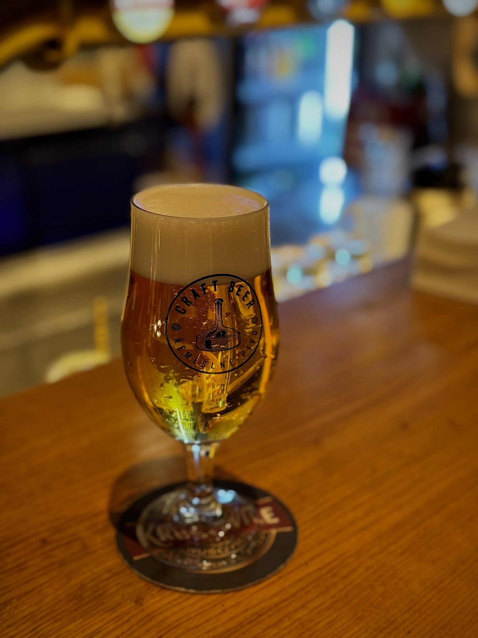 A glass of Krušovice Weizenberg wheat beer with a rich head, served at the A. Dvořák restaurant
