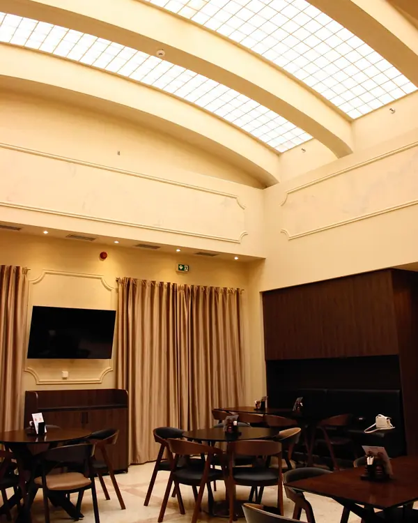 The hall with the glass ceiling and laid tables