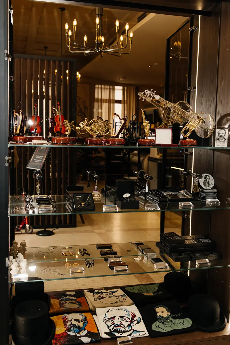 A glass display case with souvenirs, and T-shirts bearing portraits of the composer