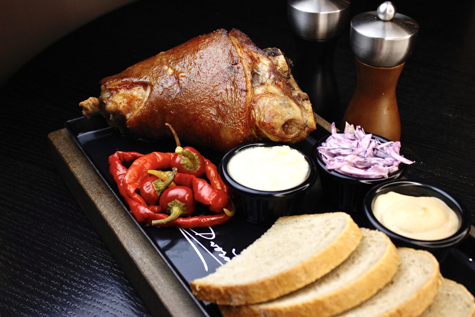 A traditional Czech dish – roast pork knuckle with cabbage, horseradish and bread at the A. Dvořák restaurant in Prague.