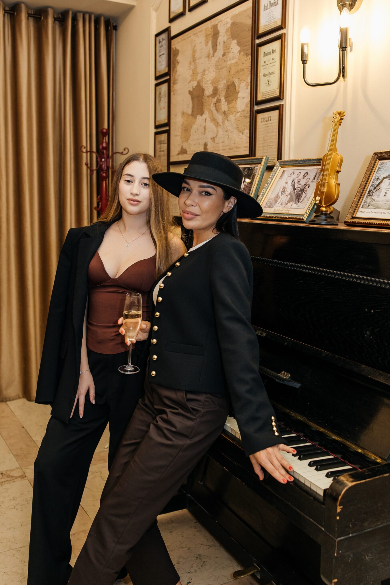 Guests posing by the piano in the interior of the A. Dvořák brewery restaurant in Prague at the official opening.